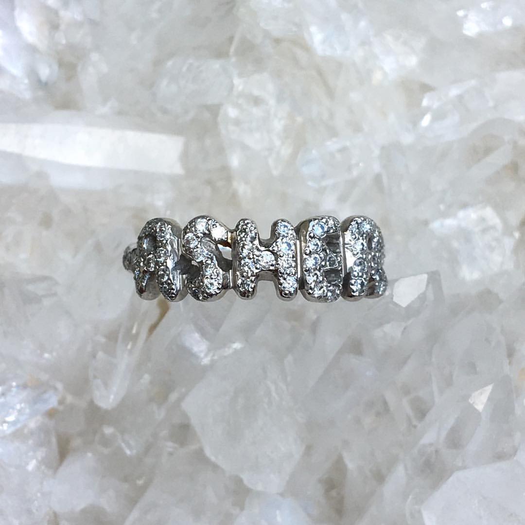 custom carved platinum name ring with diamonds