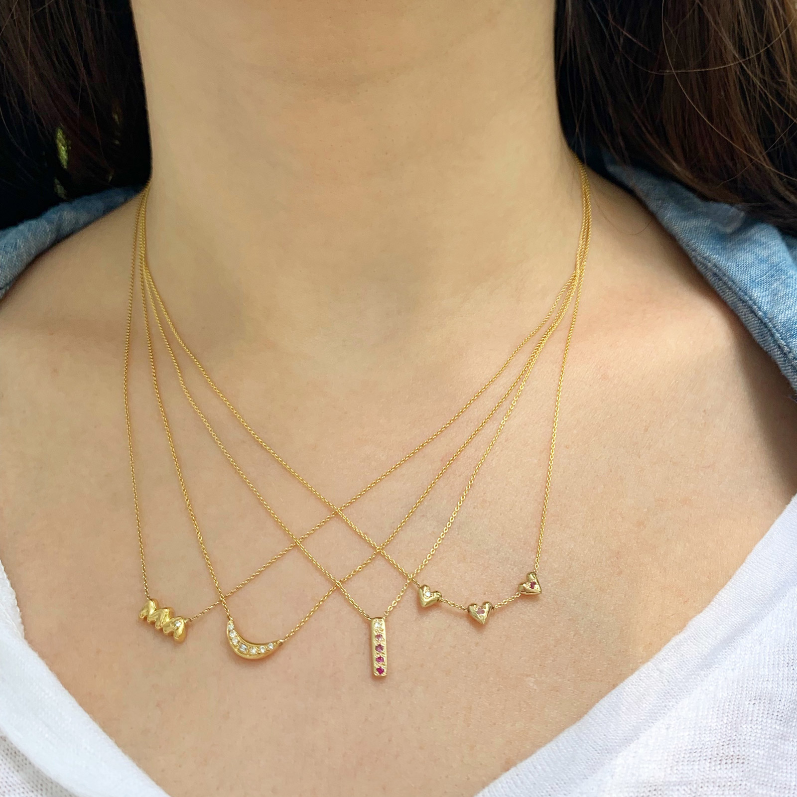 wearing the teeny tiny heart necklace and skinny bar necklace